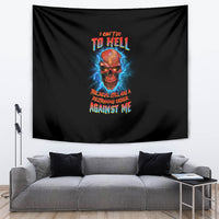 Black tapestry with skull graphic and colorful text, hung in front of gray couch
