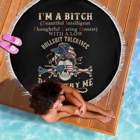 Round black beach blanket with fringed edge and skull pirate graphic, text center.