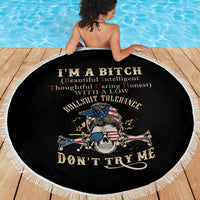 Round black beach blanket with fringed border, large skull and crossbones graphic in center.