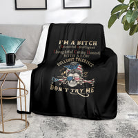 Black blanket with skull graphic and 'Don't Try Me' text on sofa with pillows