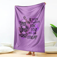 Purple graphic blanket with skull-and-rose text design, hanging/held up