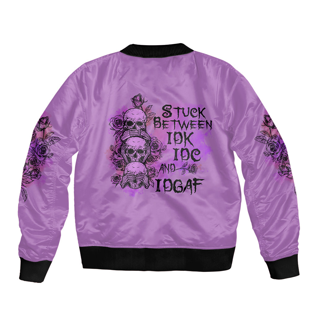 Purple bomber jacket with back print skull roses and text 'STUCK BETWEEN IDK IDC AND IDGAF'