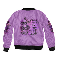 Purple bomber jacket with back print skull roses and text 'STUCK BETWEEN IDK IDC AND IDGAF'
