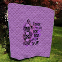 Purple quilt with diamond quilting and black graphic print, on grass