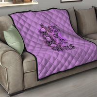 Purple quilt with diamond quilting and black graphic print on sofa