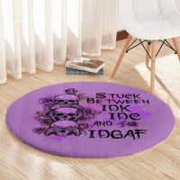 Purple round rug with black skull-and-roses graphic and stacked 'IDK IDGAF' text
