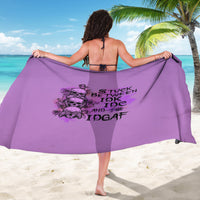 Purple sarong with black skull and slogan print, draped beach wrap