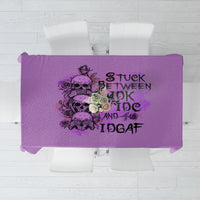 Purple tablecloth with bold black slogan graphic and flower-style design.