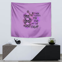 Purple tapestry with centered skull and rose illustration and bold stacked letters