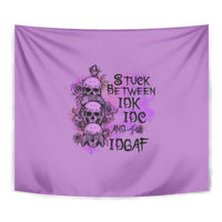 Purple tapestry close-up: skull and roses graphic with stacked distressed text