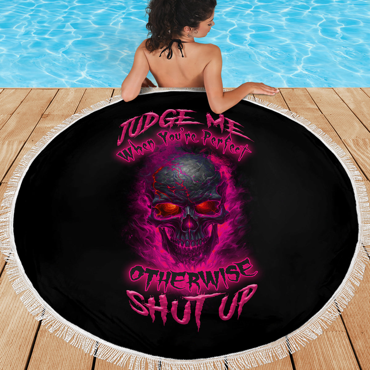 Round beach blanket with centered skull graphic, black fabric and white fringe edging