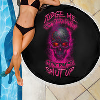 Round beach blanket near pool edge, black with purple skull graphic and white fringe border