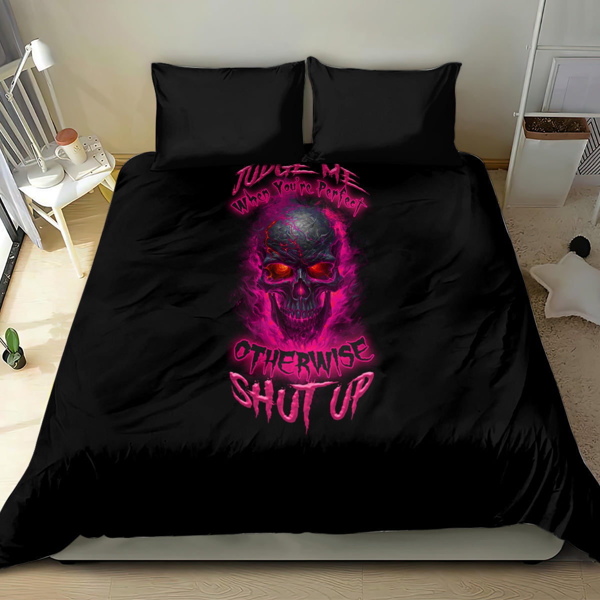 Black bedding set with two pillows and central skull graphic in pink, matching comforter