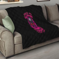 Black quilt with pink skull graphic, diamond quilted pattern on a couch throw