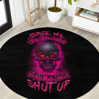 Black round carpet featuring purple skull print and stylized “Judge Me…” text