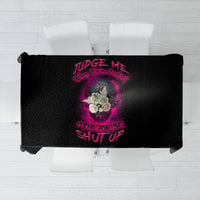 Black tablecloth laid flat with centered pink text and floral graphic