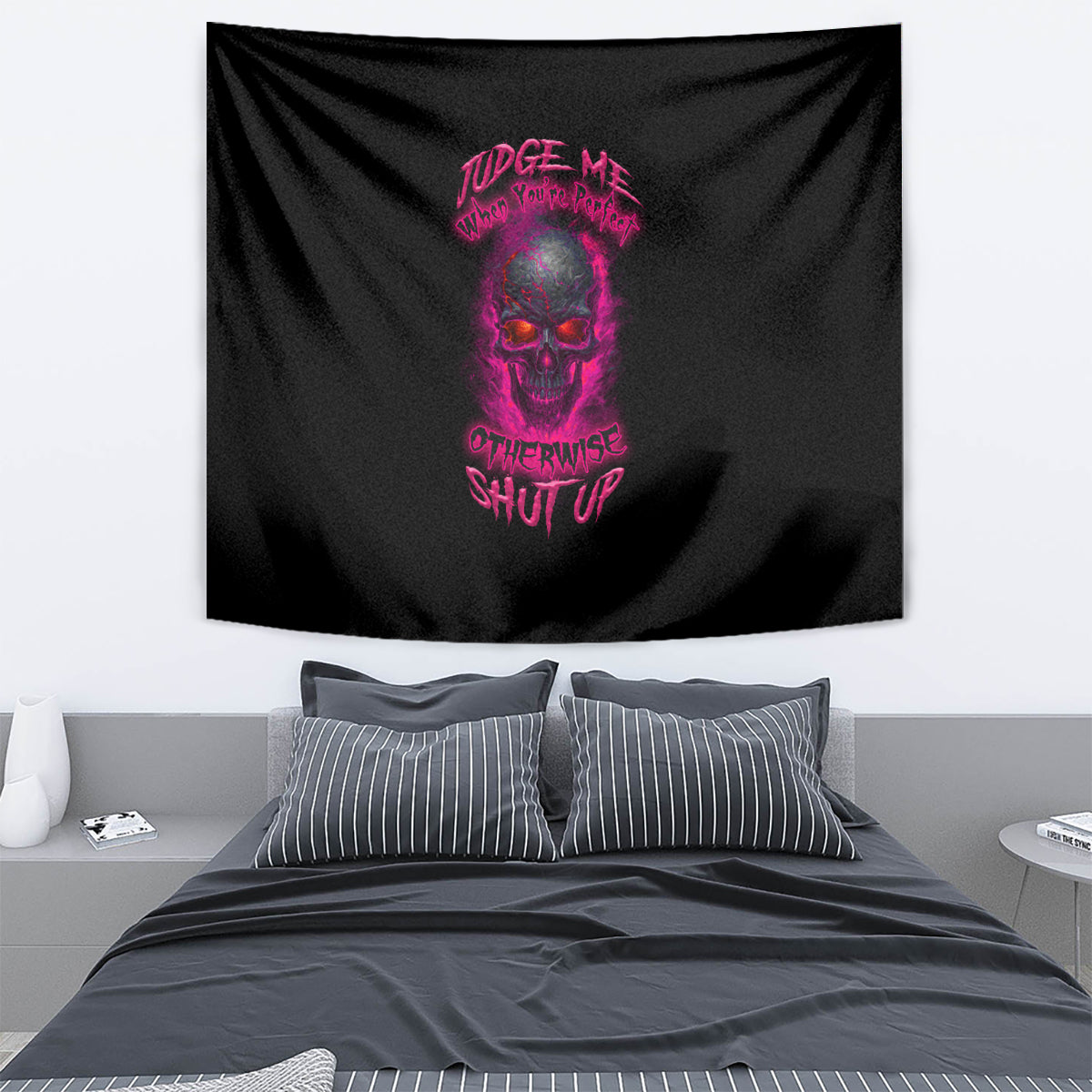 Black tapestry wall hanging with purple skull and text graphic, draped over room decor