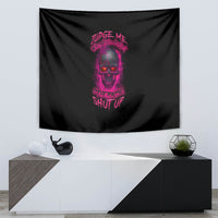 Black tapestry wall hanging with purple skull artwork and slogan text, mounted above a console