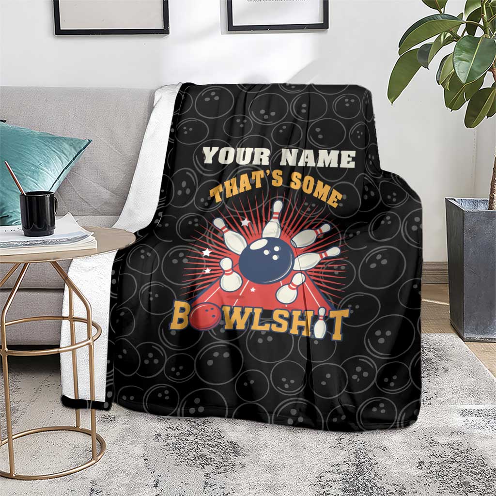 Black bowling throw blanket on floor with bowling pin graphic and 'BowlsHit' text