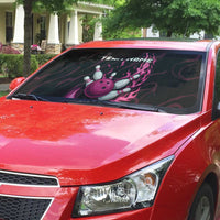 Auto sun shade on red car windshield with magenta bowling pin and flame graphic