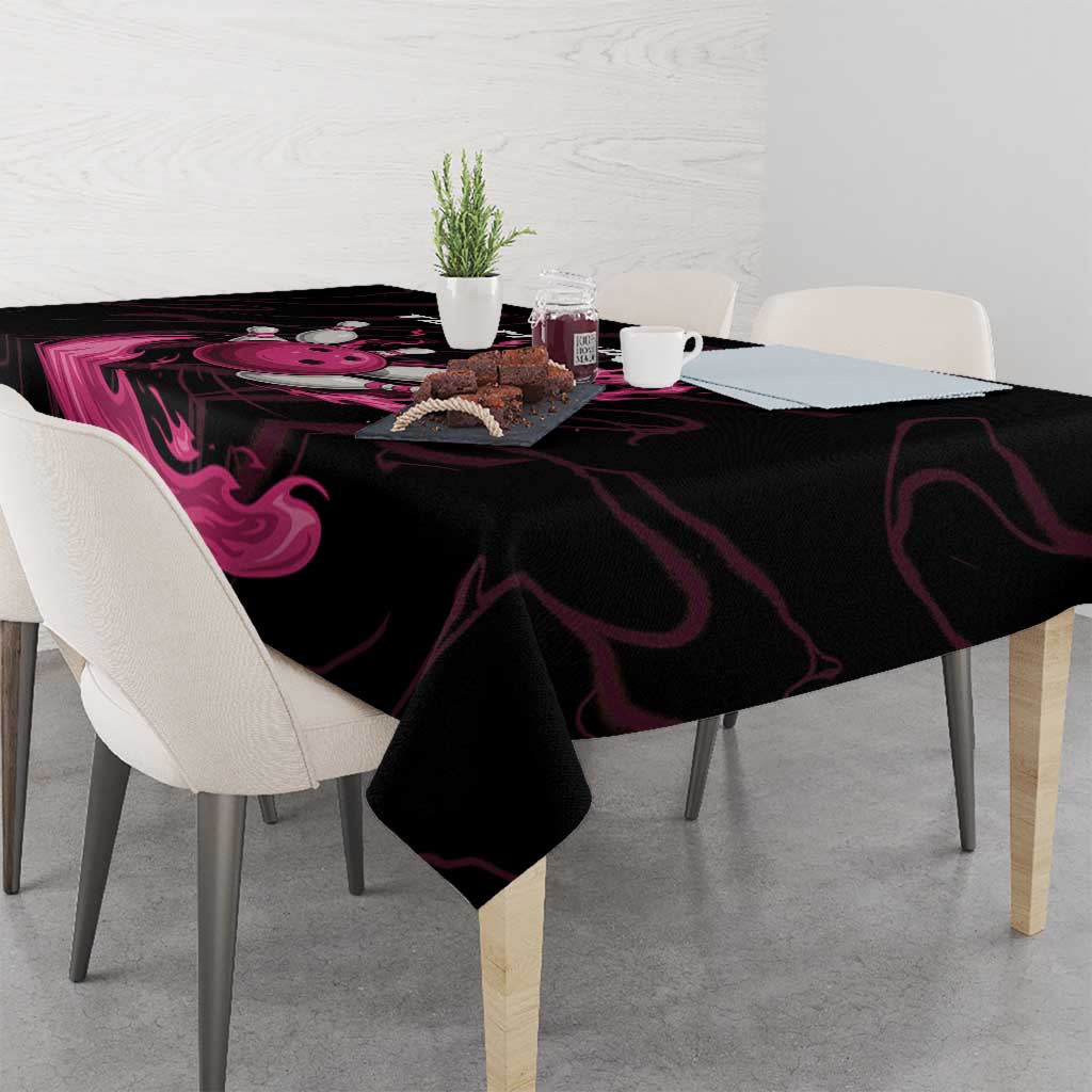 Black tablecloth with pink flame swirl graphic on dining table
