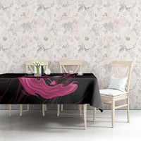Black tablecloth with pink flame swirl graphic over dining table