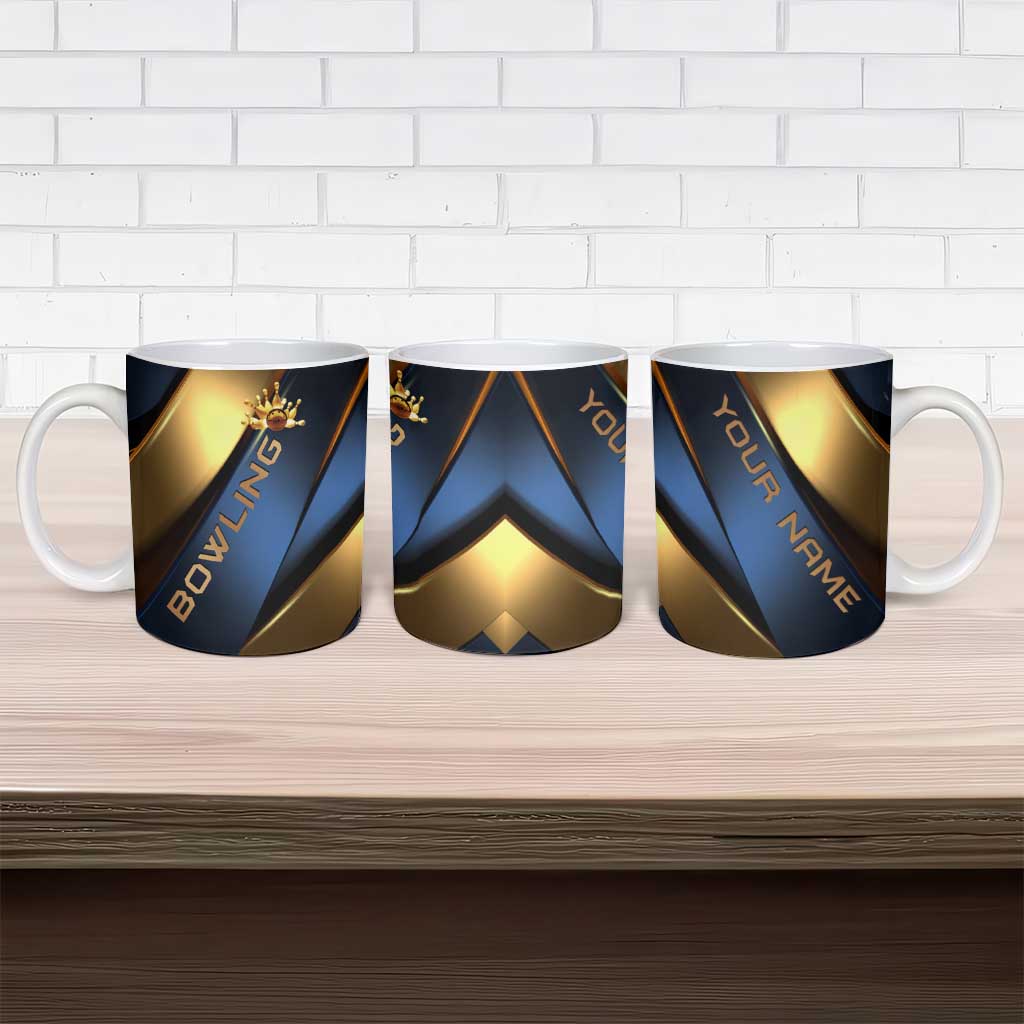 Three ceramic mugs with blue and gold bowling graphics on display