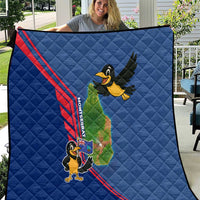 Blue quilt with quilted pattern, red stripe, cartoon bird and island map graphic.