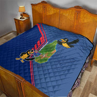 Blue quilt on bed, red stripe detail with cartoon bird and island map graphic design.