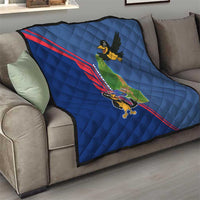 Blue quilt on living room sofa, quilted pattern with red stripe and cartoon bird island map.