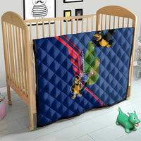 Blue quilt on crib, quilted texture with red stripe and cartoon bird island map graphic.