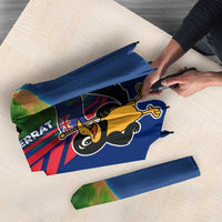 Folded blue umbrella fabric with cartoon bird and island map print, red stripe detail