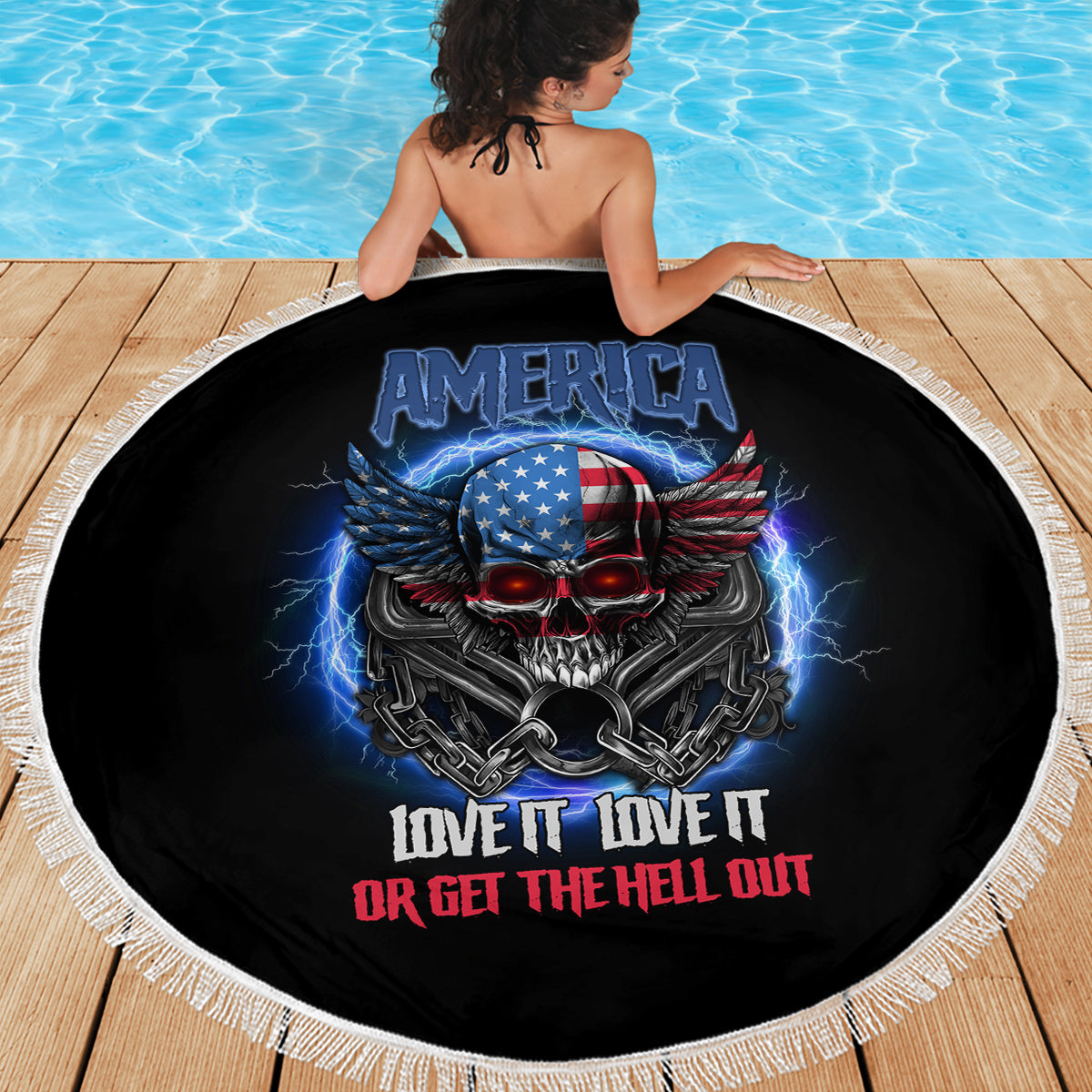 Round black beach blanket with white fringe featuring America skull with wings and slogan text.