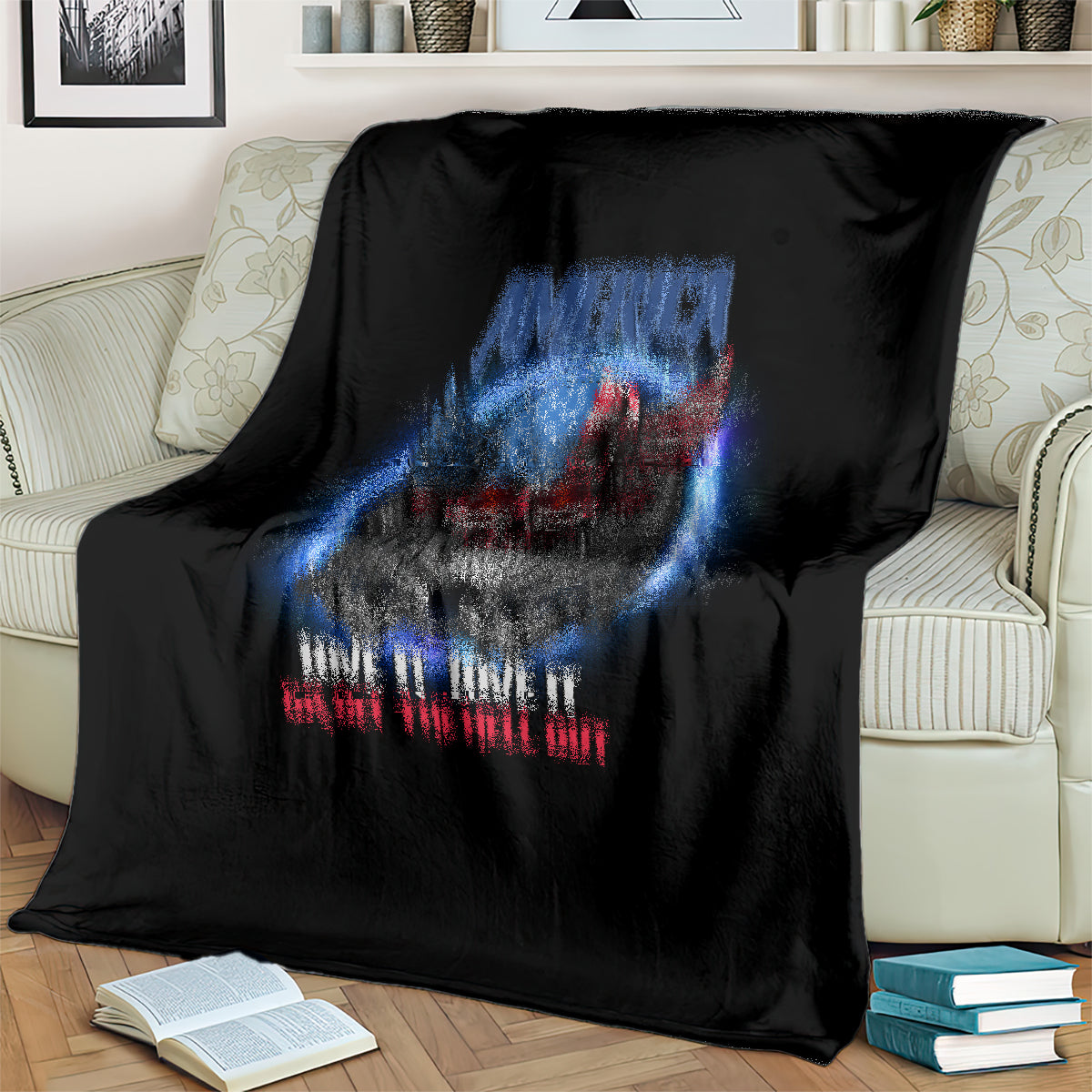 Black throw blanket showing close-up eagle skull graphic in blue and red.