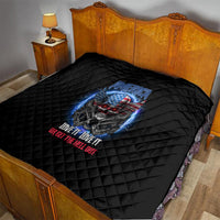 Black quilt with diamond quilting and patriotic skull graphic on bed
