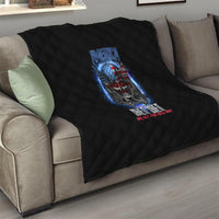 Black quilt with diamond stitching and patriotic skull graphic on living-room couch