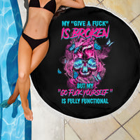Round black beach blanket with fringed edge, neon skull and quote text, poolside pose cropped.