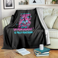 Black blanket draped on couch with neon skull design and colorful lettering