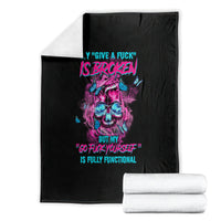 Black blanket with colorful skull graphic and neon slogan, folded with white towels