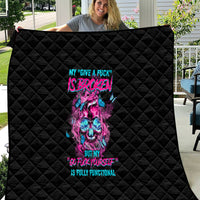 Black quilt held open, neon skull and text graphic with quilted diamond stitching