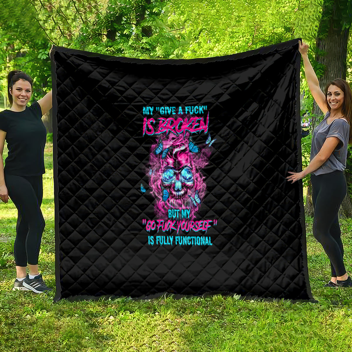 Black quilt with neon skull and text graphic, quilted diamond pattern