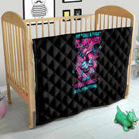 Black baby quilt in wooden crib, neon skull and text graphic, quilted diamond stitching