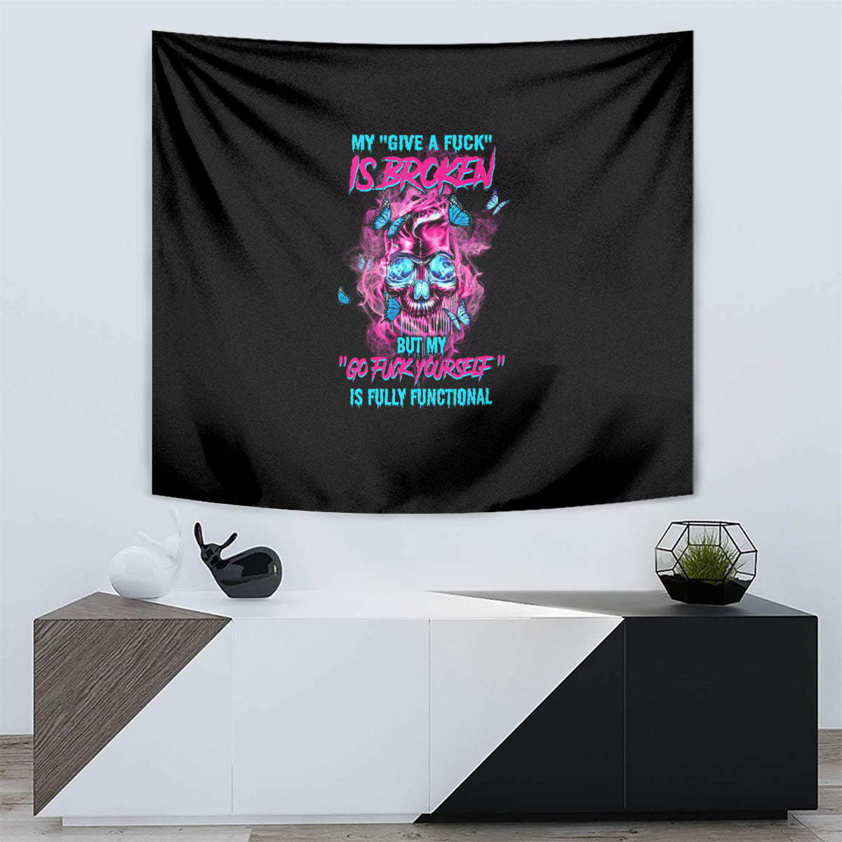 Black tapestry with centered neon skull graphic and colorful quote-style text