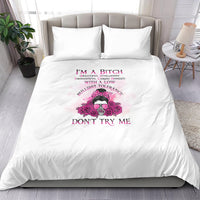 White bedding set with pink skull-and-flowers graphic, bold text on duvet, two pillowcases