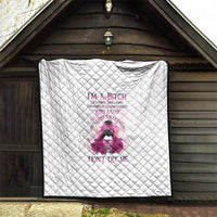 White quilt with diamond stitching and pink character rose artwork with quote.