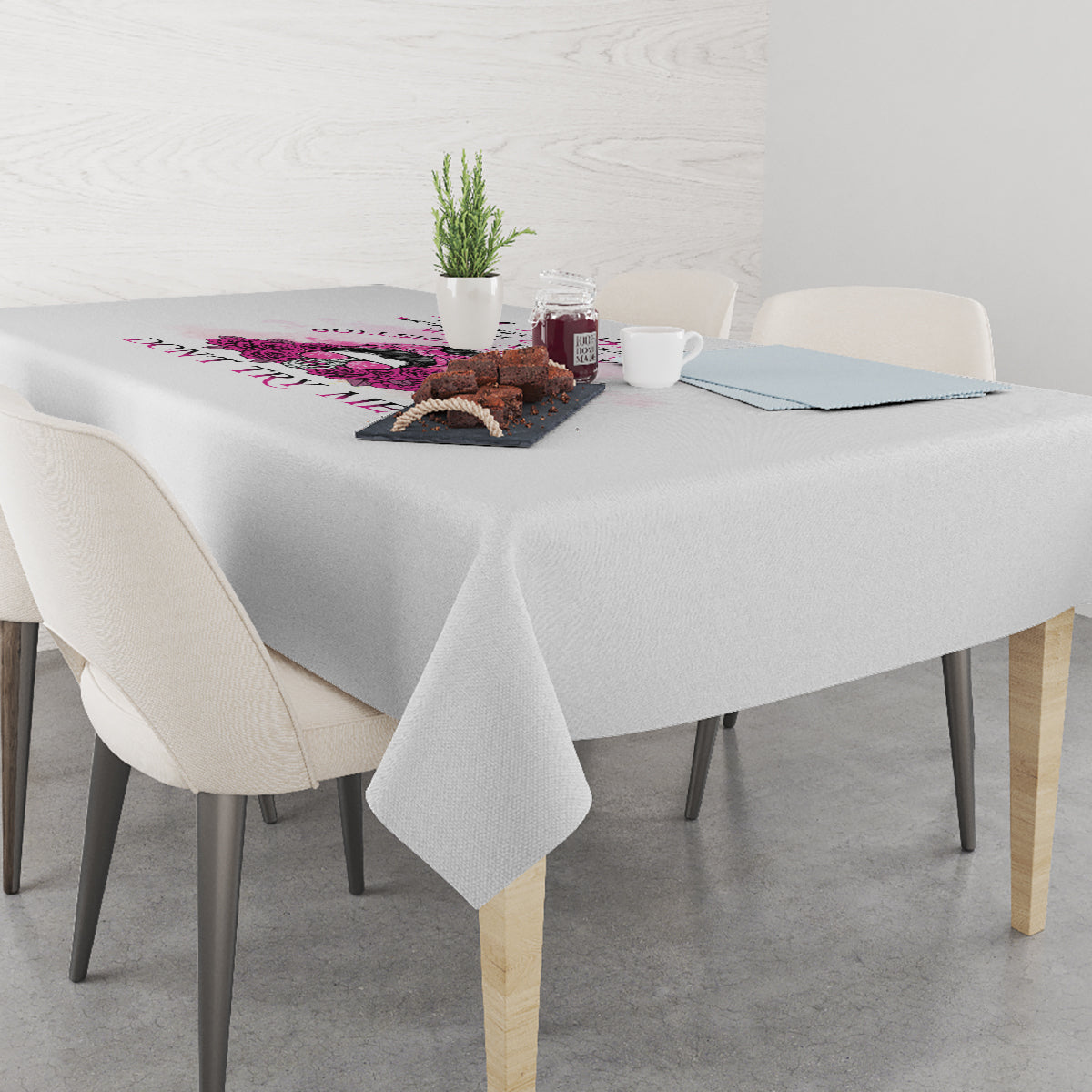 Gray tablecloth with multicolor rose and text graphic across the tabletop edge