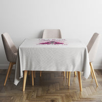 White tablecloth with small multicolor rose and text graphic near the center