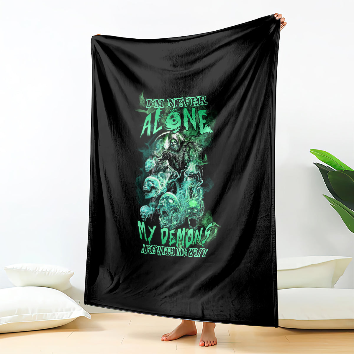 Black blanket with green reaper skull artwork, hung and covering the floor