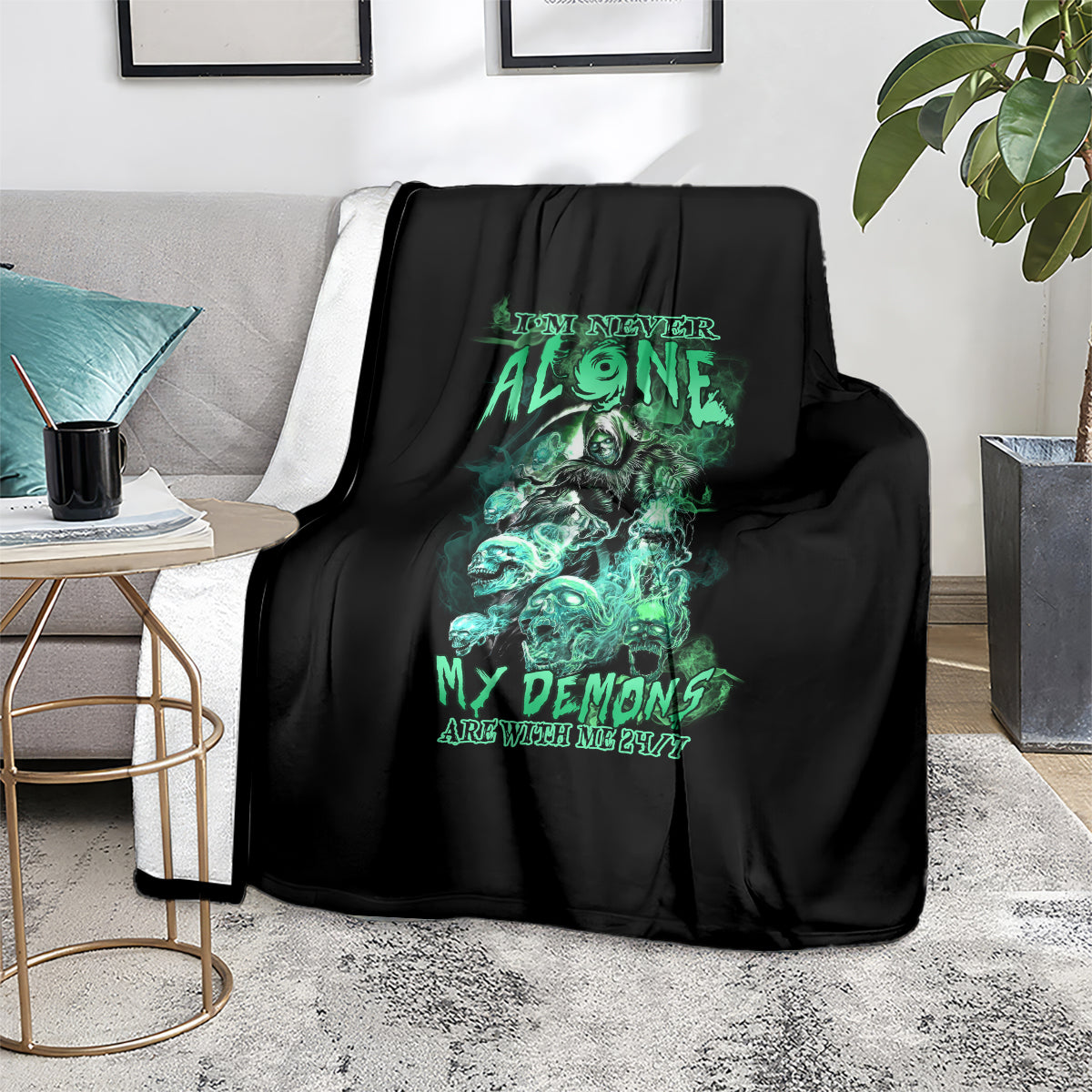 Black couch blanket with green reaper skull graphic, folded over the seat