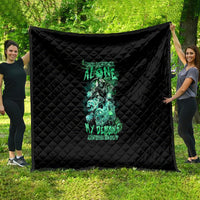 Black quilt with teal skull reaper graphic and text, diamond stitched pattern